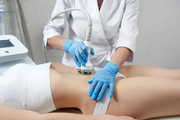 Lost the Weight but Not the Loose Skin? 2 woman having HIFU treatment on her stomach to combat loose skin Stanford-le-Hope following weight loss